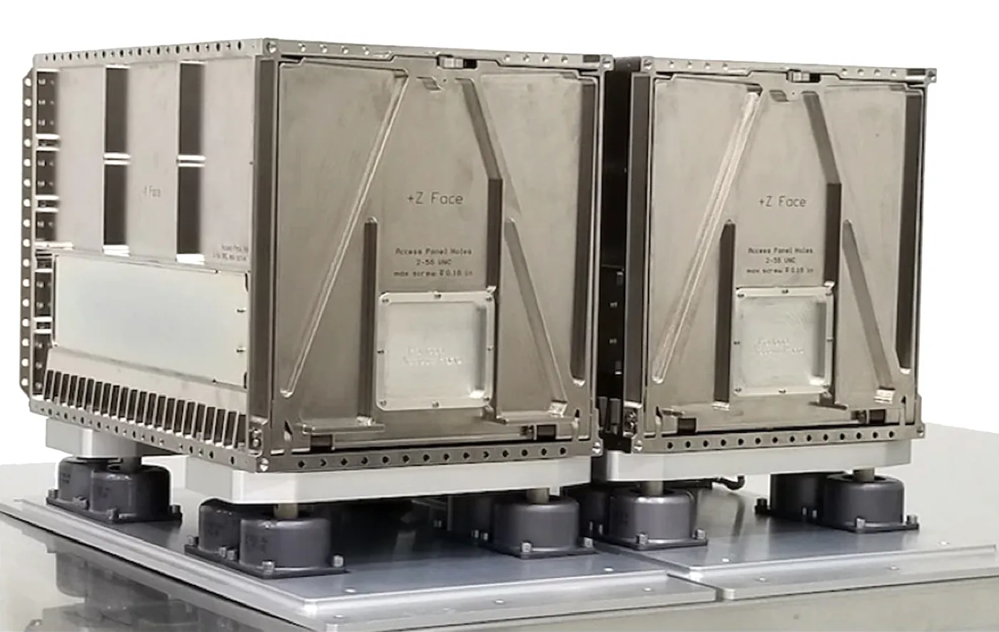 The EZ-3 and EZ-4 canisterized dispensers mounted side by side on isolators above the adapter plate.